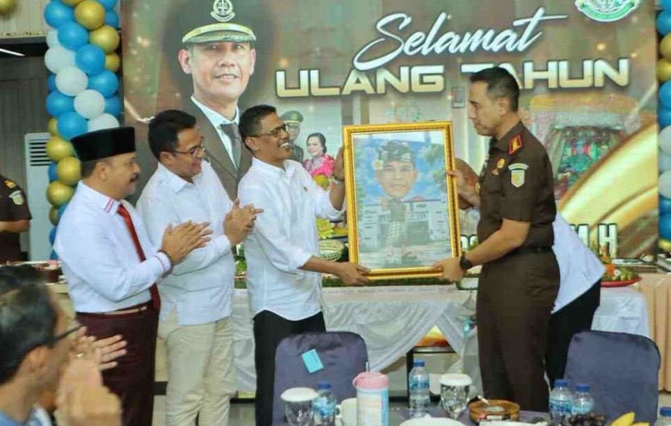Pimpinan DPRD Kota Batam menyerahkan cinderamata karikatur kepada Kajari Batam I Wayan Wiradarma saat syukuran ulang tahun ke-50.